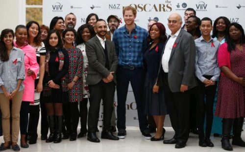 Prince Harry poses with staff and donors of Naz CREDIT: PETER NICHOLLS/REUTERS